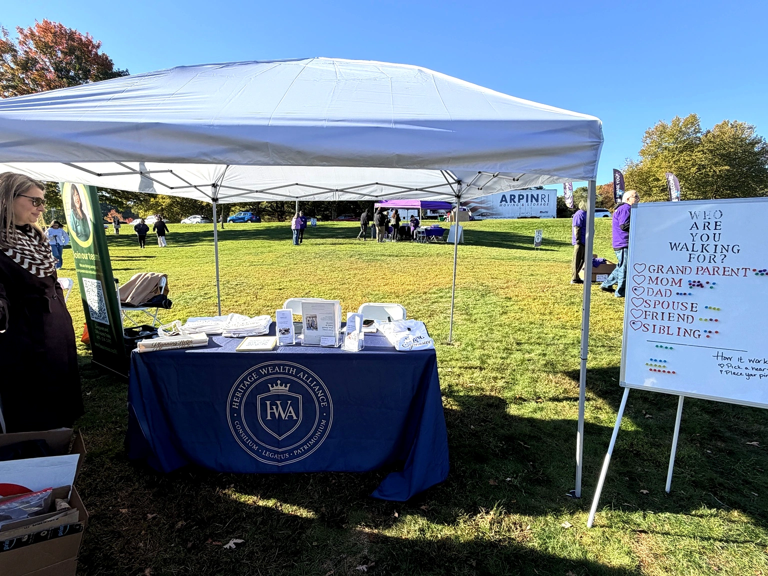 Heritage Wealth Alliance sponsorship table at the walk
